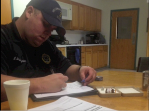Paramedic Justin McLaughlin filling out a report during his daily job duties. 