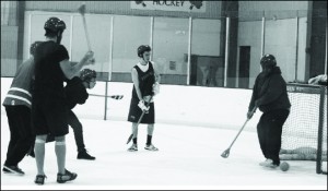 Members of Delta Tau Delta play Broomball with unaffiliated men hoping to join fraternities.