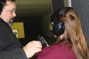 Todd Hicks gives Crispin a lesson at the shooting range.