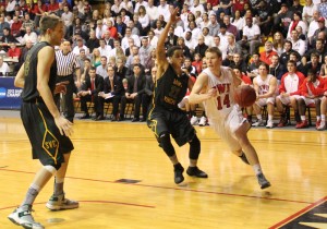 Senior Andy Winters dribbles around a Bearcat defender.  Winters lead the Bishops with 21 points and four assists.