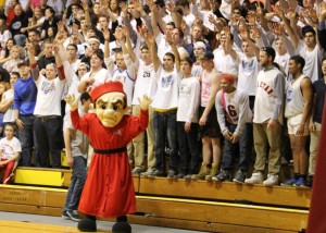 The Bishop joins the OWU student section in celebrating during Saturday’s NCAA match-up against St. Vincent.  The Bishops defeated the Bearcats 84-75 to advance in the tournament.  Their next game will be Saturday against Cabrini at home in Branch-Rickey Arena.
