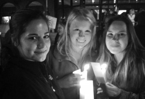 Freshmen Brittany Spicer, Megan Finke and Emily Slee hold candles lit in memory of victims and survivors of sexual violence on the JAYWalk prior to the start of the march, a demonstration against sexual violence.