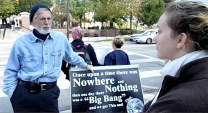 Jerry, one of the preachers, debates with freshman Aletta Doran, while sophomore Lane Bookwalter (center left) and junior Sally Stewart (center right) hold signs in the background. Stewart and sophomore Katie Berger started the protest.  Photo by Spenser Hickey