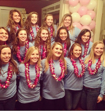 Delta Gamma new members drop their anchors and pose with traditional Hawaiian leis. 