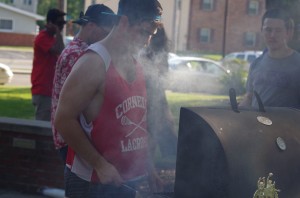 Junior Rocky Crotty, a member of Delta Tau Delta, cooks hamburgers for students at Beach Bash, the fraternity's annual event benefitting the Juvenile Diabetes Research Fund. Photo by Spenser Hickey