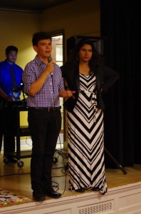 Sophomore Michael Mora-Brenes, vice president of Latin-American cultural club VIVA, speaks at the opening dinner for Hispanic Heritage Month. Sophomore Rosa Escobar, president, stands alongside. Photo by Spenser Hickey