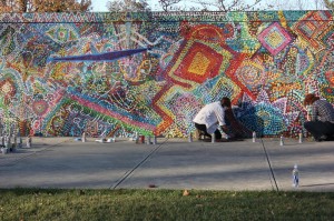 Students place finishing touches on the mural outside Hamilton-Williams Campus Center. Photo by Karson Stevenson for the Office of Marketing and Communications