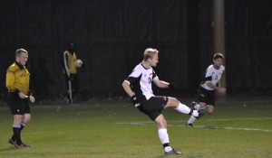 Senior Colton Bloecher fires a free-kick opportunity against Kenyon College at the Jay Martin Soccer Complex on Nov. 8. Photo by Graham Lucas