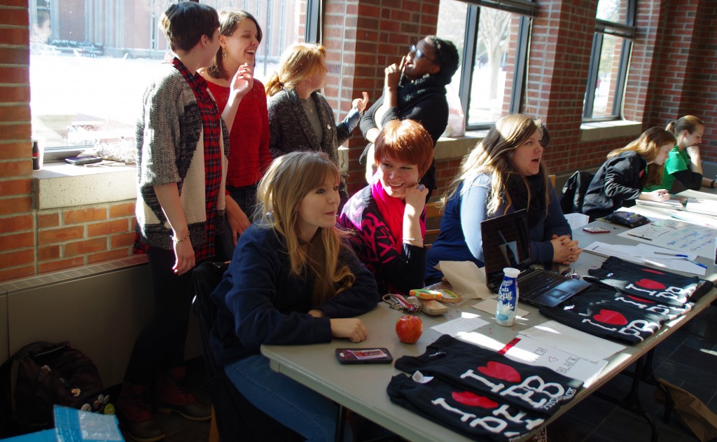 Pitch Black members sell tickets, shirts and stickers Jan. 27. Front row: Abi Horvat, Hannah Simpson and Alanna Spalsbury. In back: Abby Hanson, Alyssa Clark, Audrey Bell and Brianna Robinson.