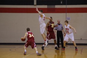 Sophomore wing Ben Simpson jumps past Oberlin guard Ian Campbell. Photo courtesy of Spenser Hickey.