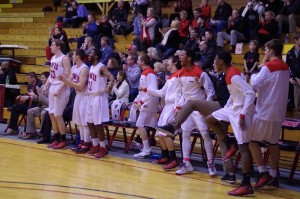 The team reacts to junior post Claude Gray's fast break score. Photo courtesy of Spenser Hickey.