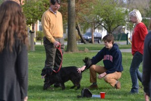 President Rock Jones and his daughter, senior Anna Jones, pet the family dog at Rock the Block. Photo courtesy of Spenser Hickey.