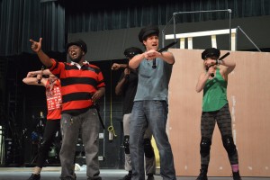 Sophomore Reggie Hemphill and Senior Luke Scaros, both portraying police officers, rehearse a musical number for the show. Photo courtesy of Alanna Easley.