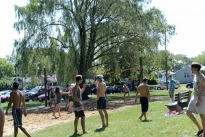 Students mingle by the sand volleyball court. Photo by Susan Ugalde.