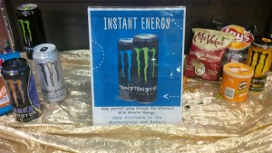 The Monster Energy Drink promotional sign placed on a shelf near food items by Chartwells. Photo by Dan Sweet '16.