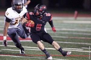 An OWU football player attempts to evade a player from Oberlin. Photo courtesy of battlingbishops.com.