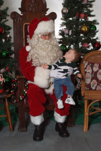 A child in Delaware sits on Santa's lap during a previous December First Friday event. Photo courtesy of the Main Street Delaware website.