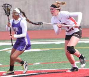 Freshman Kelsey Bowling rushes to defend a Capital attacker in a recent loss to the Crusaders. Photo by Leia Mizas.